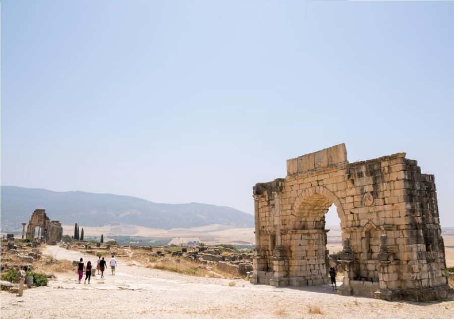From Fez: Volubilis, Moulay Idriss and Meknes Full Day Tour - Volubilis Roman Ruins: Arch of Caracalla, Basilica, and City Layout