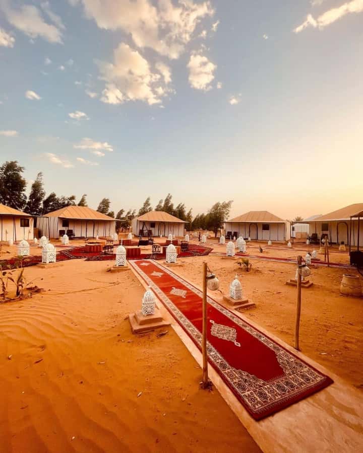 From Merzouga: Overnight Camel Trek over Erg Chebbi Dunes - Day 1 on the dunes: sunset ride, sandboarding, tagine, and drum circle