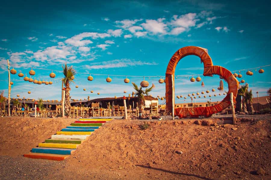 Marrakech: Camel Ride, Dinner, Pool, and Fire Show in Agafay - Moroccan Dinner Under the Stars: Couscous and Tagine